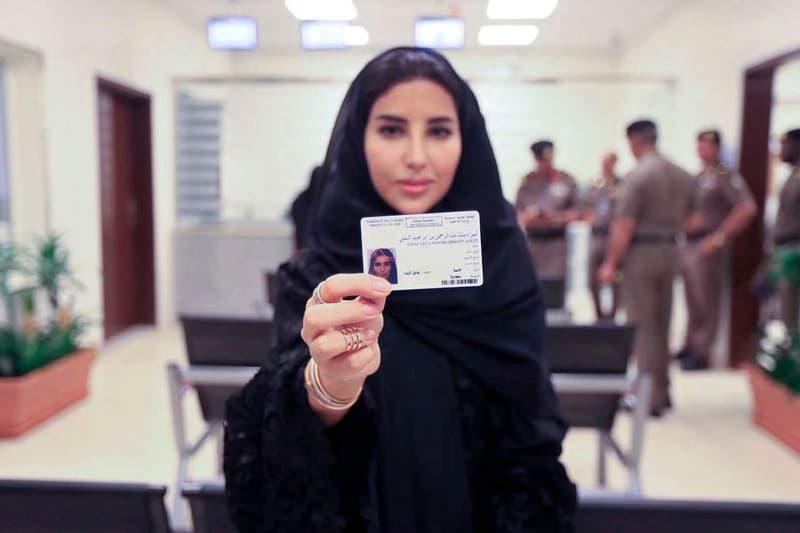 Saudi woman holding a driver's license.